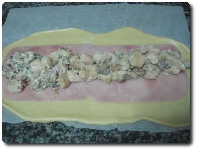  Extendemos por encima una porción de relleno de champiñones, pollo y beicon, sin llegar hasta los bordes.